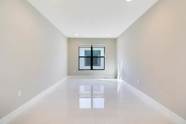 a view of a kitchen with kitchen island a sink stainless steel appliances and cabinets