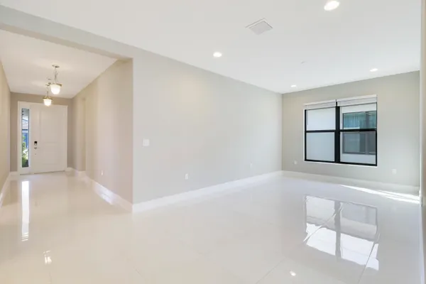 a view of a kitchen with kitchen island a sink stainless steel appliances and cabinets