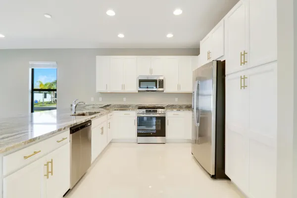 a view of a living room a kitchen and a couch