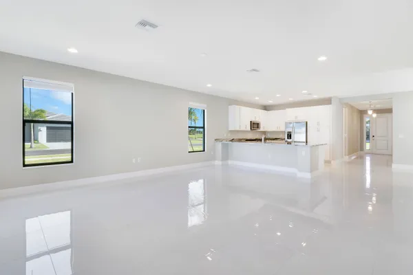 an aerial view of a house with garden space and ocean view