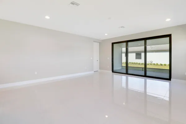 a view of a chair and tables in patio with a swimming pool