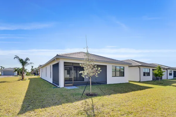 a living room with furniture and a dining table with wooden floor