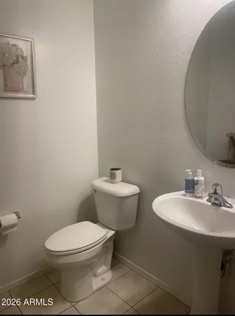 a white toilet sitting next to a bathroom sink