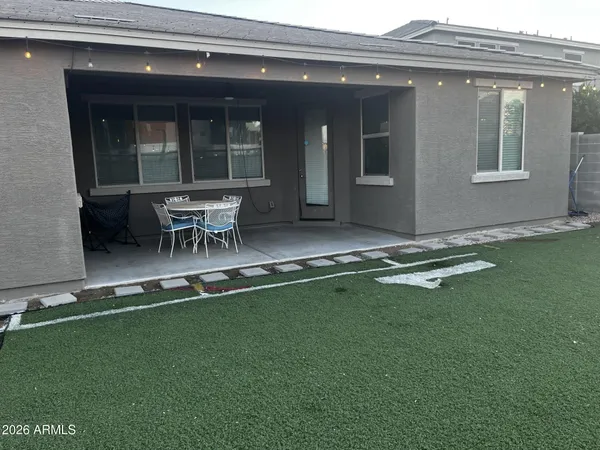 a view of a house with a backyard and sitting area