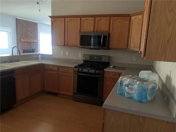 a metallic refrigerator freezer sitting in a kitchen