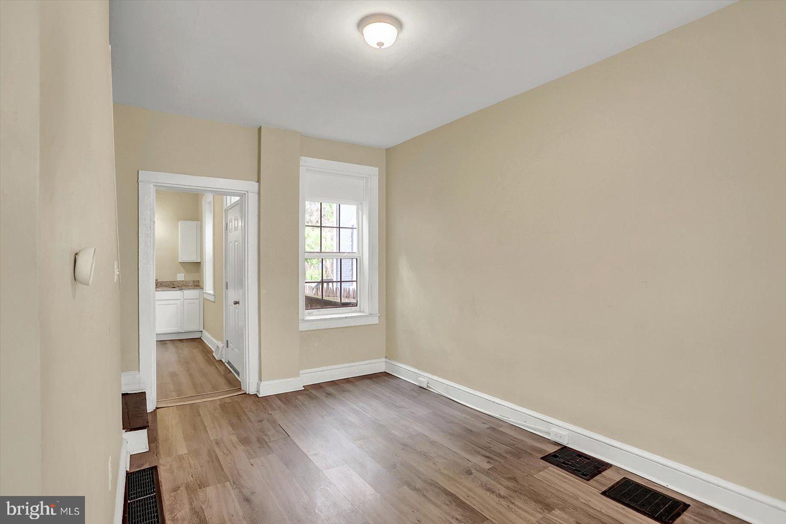 316 Beaver Street Lancaster, PA 17603 - Photo 8 of 34 an empty room with wooden floor and windows
