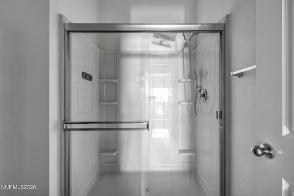 a bathroom with a glass shower door