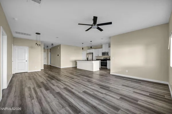 a view of kitchen with refrigerator and window