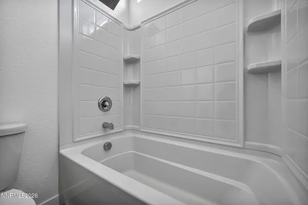 a kitchen with stainless steel appliances a white stove top oven and white cabinets
