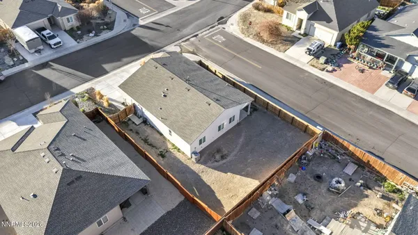 a kitchen with stainless steel appliances granite countertop a refrigerator a sink dishwasher a stove and white countertops with wooden floor