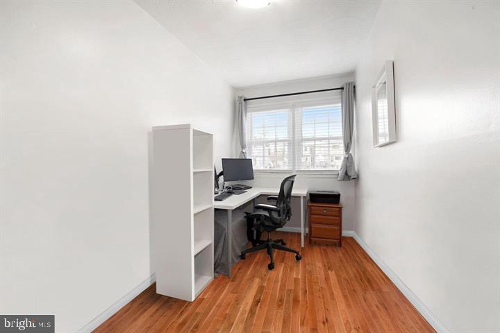 3528 Beech Avenue Baltimore, MD 21211 - Photo 12 of 19 a workspace with furniture and wooden floor