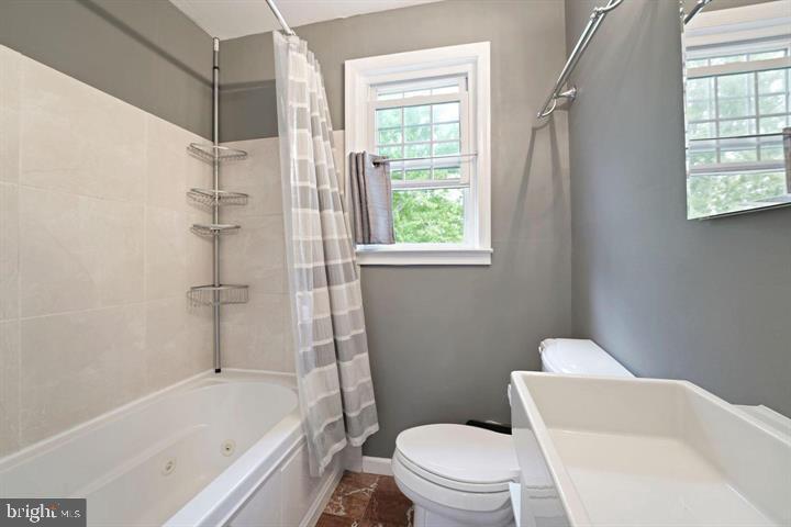 3528 Beech Avenue Baltimore, MD 21211 - Photo 13 of 19 a white toilet sitting next to a bath tub shower
