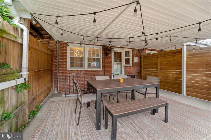 3528 Beech Avenue Baltimore, MD 21211 - Photo 17 of 19 a roof deck with a dining table and chairs with wooden floor