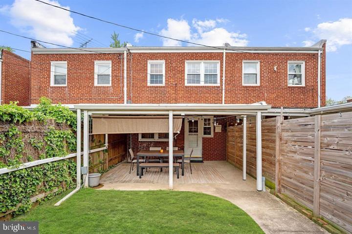 3528 Beech Avenue Baltimore, MD 21211 - Photo 19 of 19 a view of a house with a deck and a yard