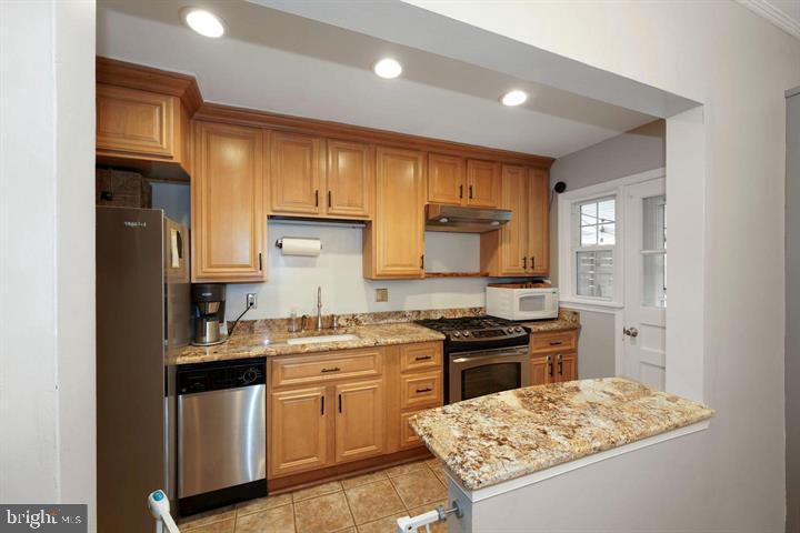 3528 Beech Avenue Baltimore, MD 21211 - Photo 6 of 19 a kitchen with a sink stove and refrigerator