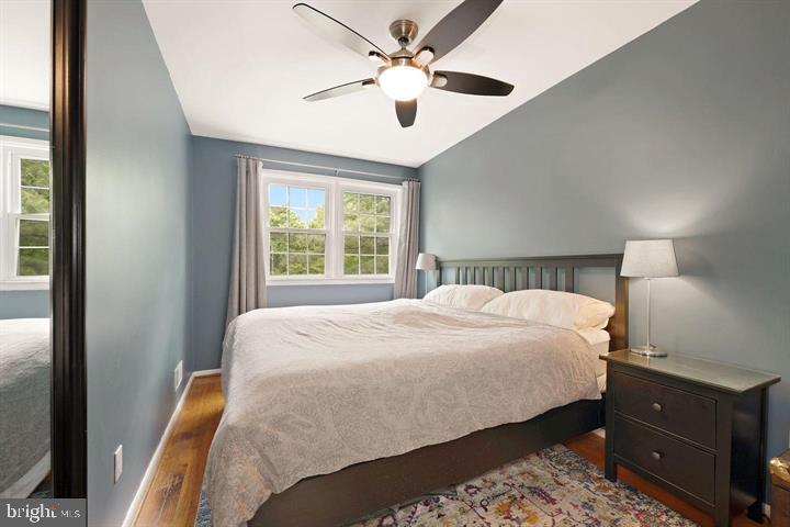 3528 Beech Avenue Baltimore, MD 21211 - Photo 10 of 19 a bedroom with a bed and a chandelier