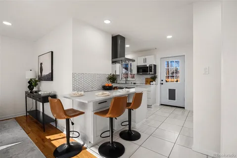 a kitchen with stainless steel appliances kitchen island granite countertop a sink and cabinets
