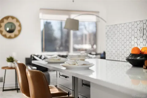 a dining room with furniture and a mirror