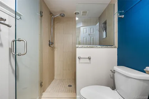 a bathroom with a toilet and a shower