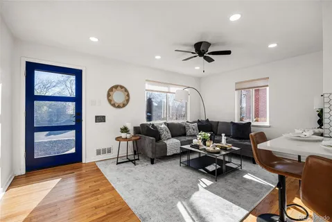 a living room with furniture a rug and a window