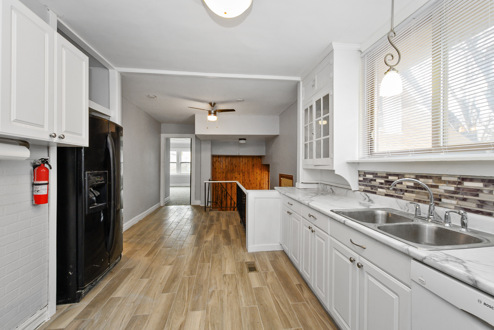 14823 Grant Street Dolton, IL 60419 - Photo 15 of 37 a kitchen with a sink dishwasher a refrigerator and a stove with wooden floor