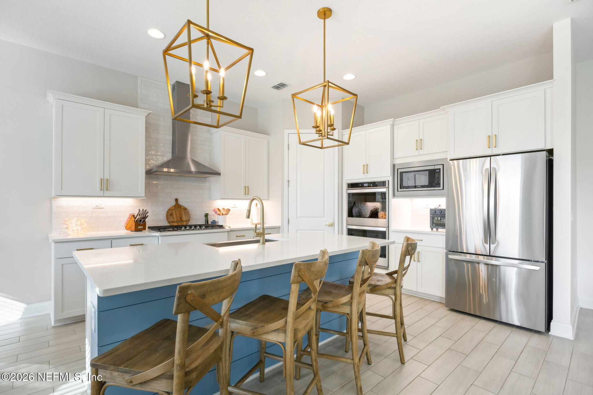 668 Rum Runner Way St. Johns, FL 32259 - Photo 17 of 81 a kitchen with stainless steel appliances a dining table chairs refrigerator and microwave
