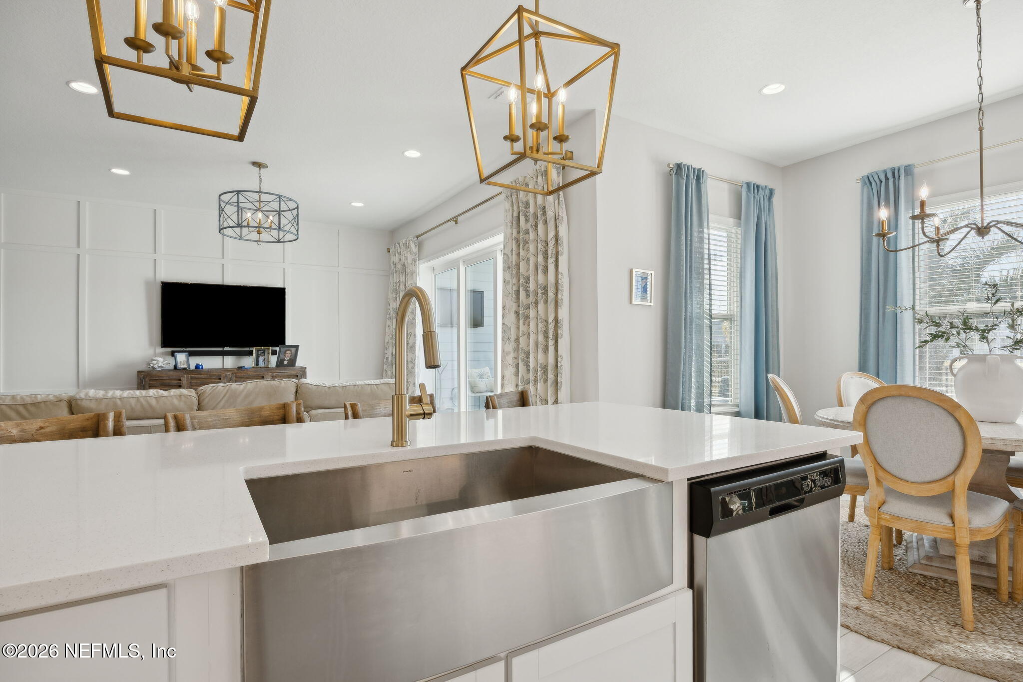 668 Rum Runner Way St. Johns, FL 32259 - Photo 20 of 81 a kitchen with stainless steel appliances a sink a table a flat screen tv and a chandelier