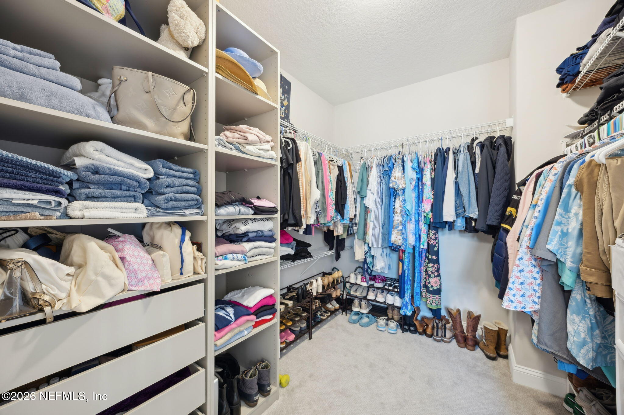668 Rum Runner Way St. Johns, FL 32259 - Photo 32 of 81 a view of walk in closet with clothes and shoes