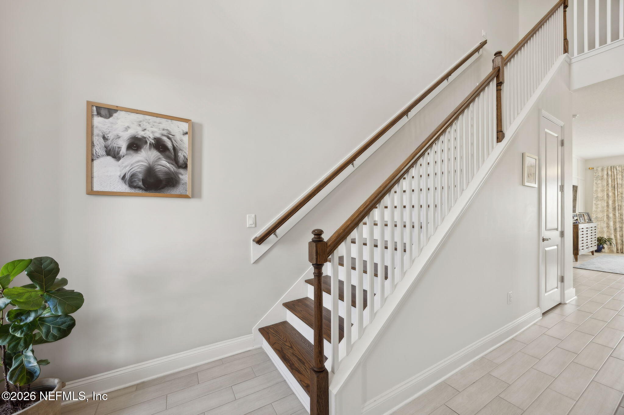668 Rum Runner Way St. Johns, FL 32259 - Photo 4 of 81 a view of staircase with wooden floor and white walls