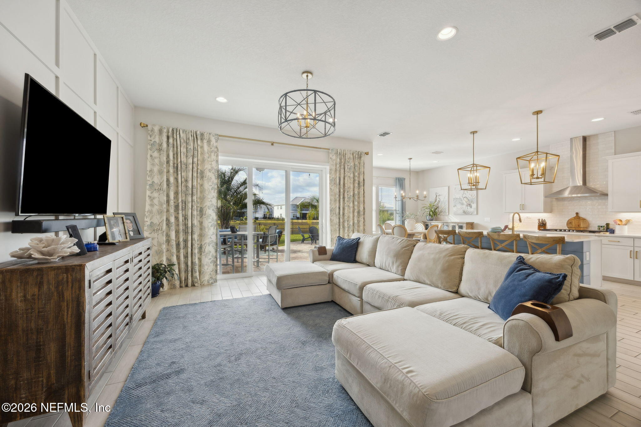 668 Rum Runner Way St. Johns, FL 32259 - Photo 6 of 81 a living room with furniture and a flat screen tv