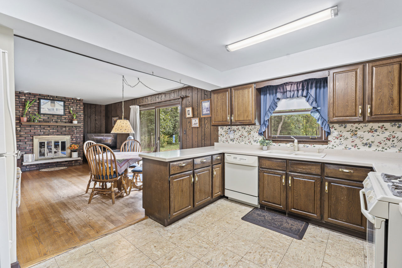 245 Bradwell Road Inverness, IL 60010 - Photo 11 of 43 a kitchen with stainless steel appliances granite countertop a table chairs and a refrigerator