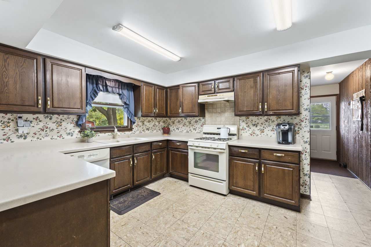 245 Bradwell Road Inverness, IL 60010 - Photo 12 of 43 a kitchen with kitchen island granite countertop a sink cabinets and stainless steel appliances