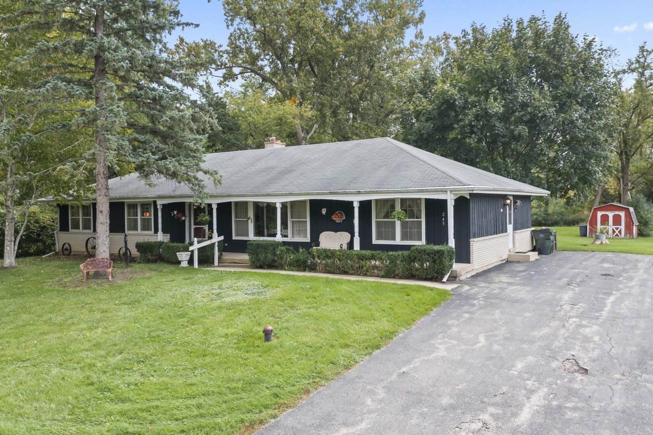 245 Bradwell Road Inverness, IL 60010 - Photo 3 of 43 a front view of a house with a garden and porch