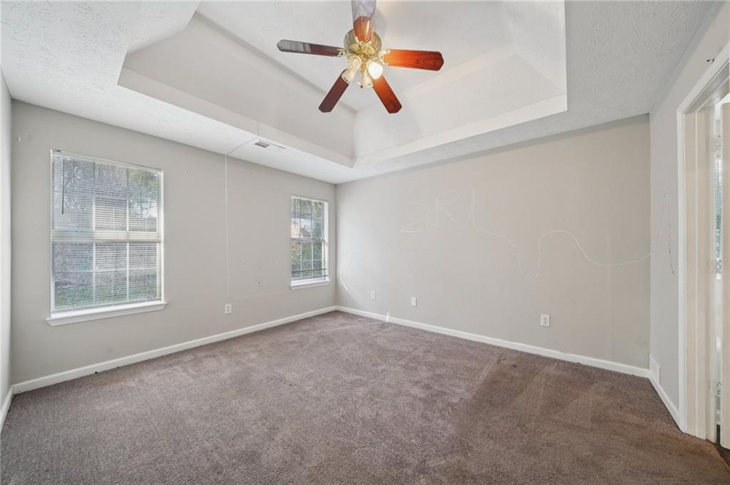 1443 Pebble Ridge Lane Hampton, GA 30228 - Photo 13 of 24 an empty room with windows and fan