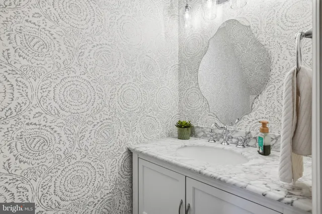 a view of a dining room with furniture a chandelier and wooden floor