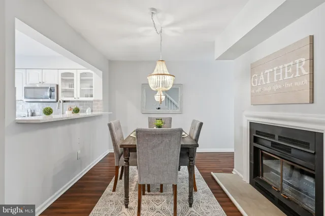 a view of a dining room with furniture wooden floor and chandelier