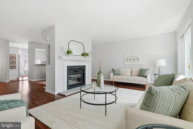 a living room with furniture a fireplace and a table