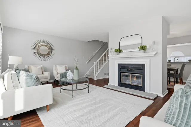 a kitchen with granite countertop white cabinets and stainless steel appliances