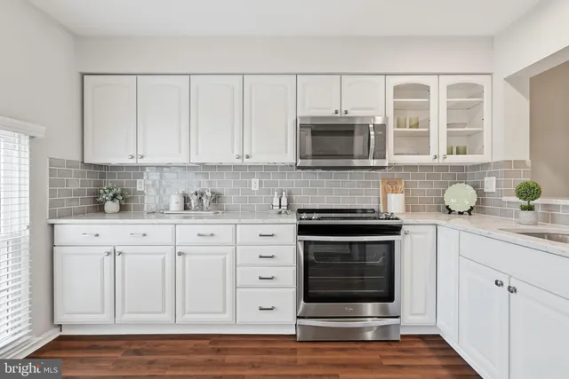 a bathroom with a granite countertop sink a mirror and vanity