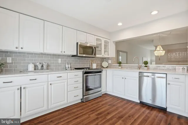 a view of a hardwood floor and windows in a room