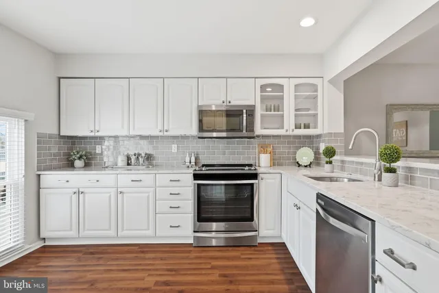 a bathroom with a toilet a sink and a mirror