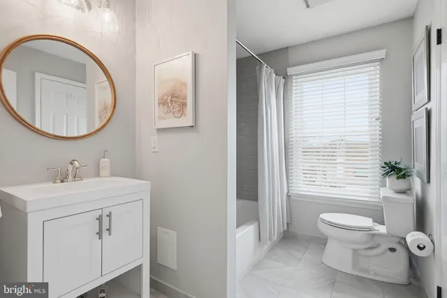 a bedroom with a bed and a painting