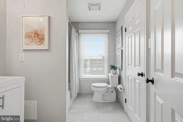 a spacious bedroom with a bed and window