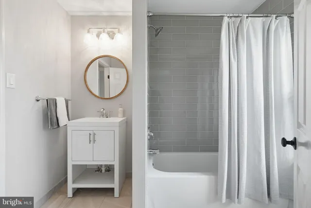 a bathroom with a sink vanity granite and shower