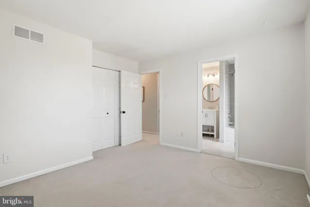 an empty room with a ceiling fan and a window
