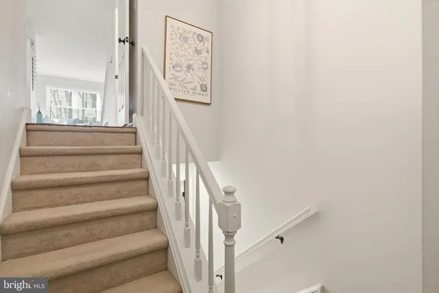 a view of a dining room with furniture a fireplace and wooden floor