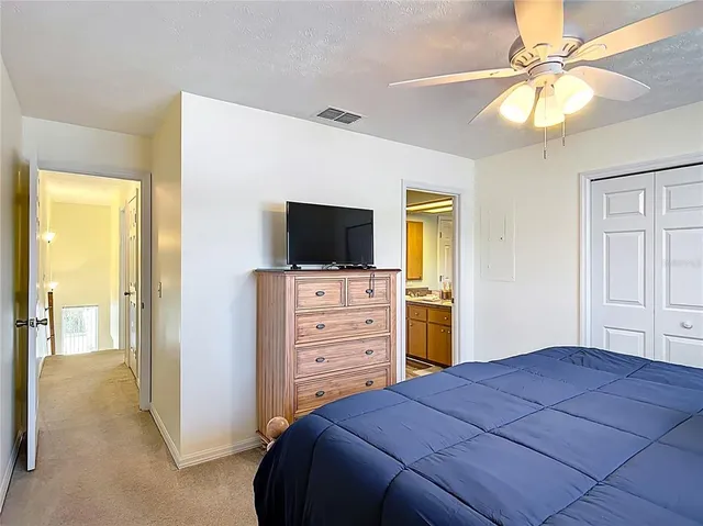 a bathroom with a granite countertop toilet sink and mirror