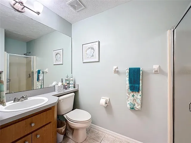 a bathroom with a glass shower door and mirror