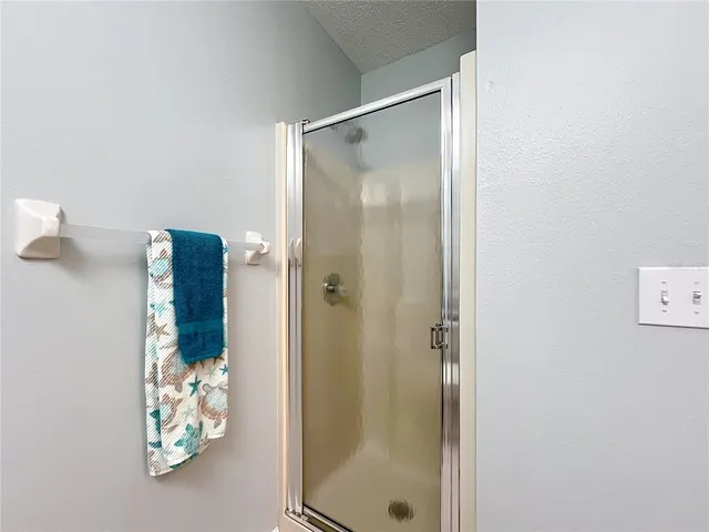 a bedroom with a bed and a lamp on dresser