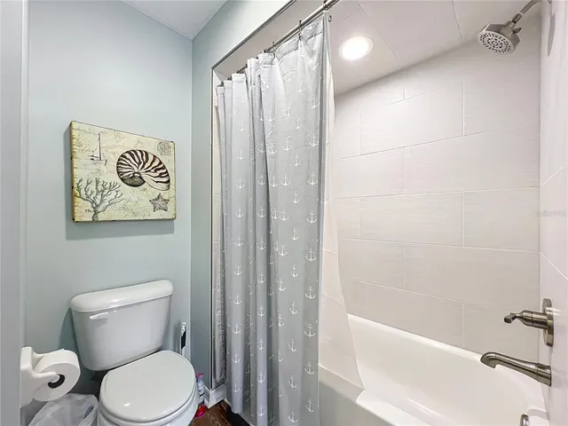 a bathroom with a toilet sink and tub